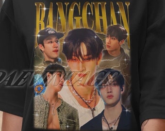 May include: Black t-shirt featuring a vintage-style graphic of a K-pop artist, Bang Chan, in gold lettering. The graphic includes multiple images of the artist in various poses.