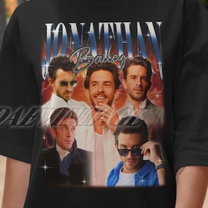 May include: Black t-shirt with a vintage-style graphic of Jonathan Bailey, featuring a collage of his photos with the text "Jonathan Bailey" in a bold, white font.