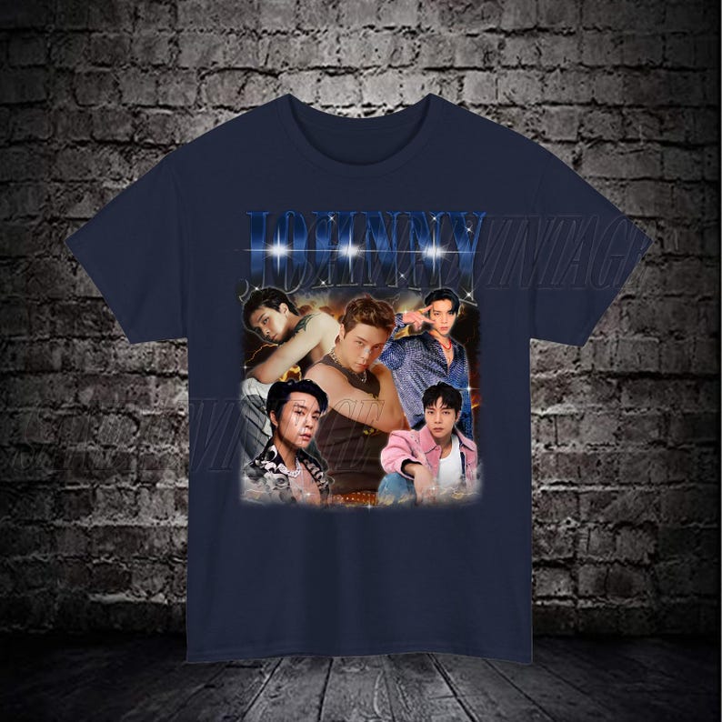 May include: A navy blue t-shirt with a vintage-style graphic featuring a collage of five men. The graphic includes the word "JOHNNY" in large, bold letters with a glittery effect.