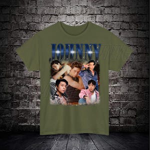 May include: A green t-shirt with a vintage-style graphic of a man's face with the word "JOHNNY" in blue letters above it.