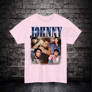 May include: Pink t-shirt with a vintage style graphic print of five men. The print features the word "JOHNNY" in large, bold letters.