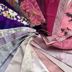 May include: A collection of fabric swatches in shades of purple, pink, and gray, arranged in a circular pattern. The fabrics display various patterns, including floral, geometric, and dotted designs. The color palette ranges from deep violet to pale pink.