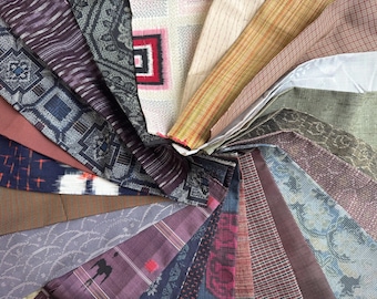 May include: A circular arrangement of various fabric swatches, showcasing a diverse range of patterns and colors. The fabrics include geometric, floral, and abstract designs in shades of blue, purple, brown, and green. The swatches are fanned out, displaying their textures and details.