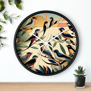 May include: A round wall clock with a black frame. The clock face features a stylized illustration of colorful birds perched on branches against a cream-colored background. Orange lines mark the hours.