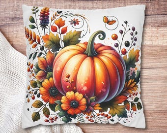 May include: A decorative white pillow featuring a vibrant autumn design. The pillow showcases a large orange pumpkin surrounded by colorful fall foliage, flowers, and berries. A small orange butterfly is also included in the design.