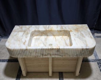 Lavandino in marmo Calacatta Gold: lavabo a parete con scanalature