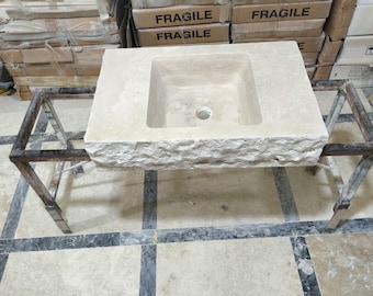 May include: A white stone bathroom sink with a rectangular shape and a square basin. The sink is sitting on a metal stand with a black finish.