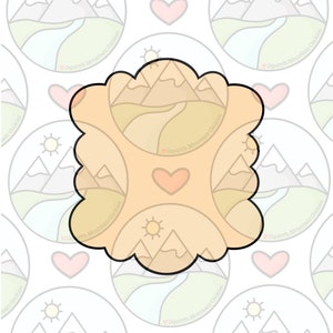 May include: A cookie cutter in the shape of a mountain range with a sun and a heart. The cutter is made of metal and has a light brown color.