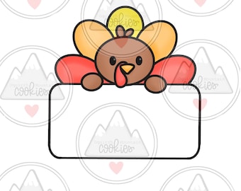 May include: A cartoon turkey with a red, orange, and yellow body is peeking over a blank white sign. The turkey has a brown head and a red beak. The sign is surrounded by a black outline.