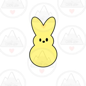 May include: A yellow cookie cutter in the shape of a bunny with a black outline. The bunny has a rounded body, a small face with two black dots for eyes, and tall ears with a heart-shaped indentation.