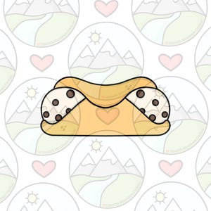 May include: A cartoon illustration of a cannoli cookie cutter. The cutter is tan with a heart in the center and two chocolate chip cookie ends. The background is a repeating pattern of mountains, suns, and hearts.