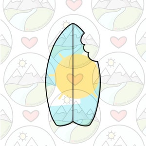 May include: A blue and yellow surfboard cookie with a bite taken out of it. The cookie is decorated with a sun, mountains, and waves.