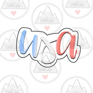 May include: A cookie cutter in the shape of the word "USA" with red, white, and blue accents. The cutter is outlined in black.