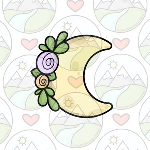 Puede incluir: Una galleta de media luna amarilla decorada con hojas verdes y flores moradas y naranjas.