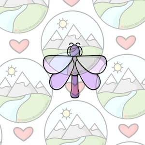 May include: Purple dragonfly cookie cutter with a mountain and sun design. The cookie cutter is on a white background with a repeating pattern of mountain and sun designs.