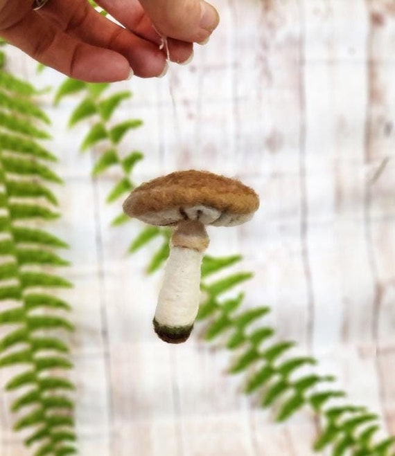 A fully hand-sculpted needle-felted mushroom ornament — each one is a tiny, tactile OOAK sculpture that looks straight out of a woodland fairy tale.