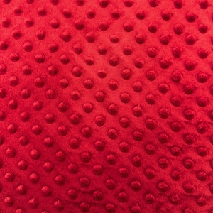 May include: Red fabric with a textured pattern of small raised circles.