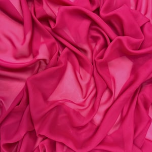 May include: A close-up of a bright pink fabric with a soft, flowing texture. The fabric is draped and folded, creating a sense of movement and fluidity.