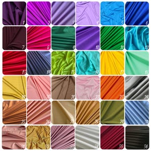 May include: A color chart showcasing various fabric swatches in a grid arrangement. The swatches display a range of colors, including purple, pink, green, blue, yellow, orange, and neutral tones. Each swatch is numbered, providing a visual guide for color selection.