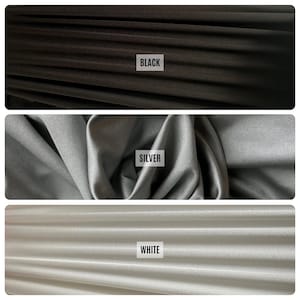 May include: Three fabric swatches in black, silver, and white. Each swatch has a label with the color name. The black fabric is at the top, the silver in the middle, and the white at the bottom. The fabric appears to be soft and flowing.