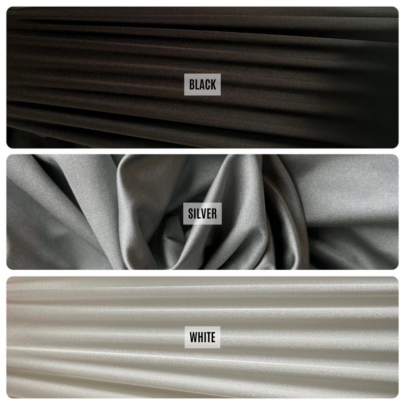 May include: Three fabric swatches in black, silver, and white. Each swatch has a label with the color name. The black fabric is at the top, the silver in the middle, and the white at the bottom. The fabric appears to be soft and flowing.