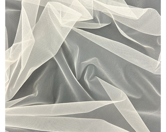 May include: White tulle fabric with a soft, delicate texture. The fabric is sheer and lightweight, with a fine mesh pattern. It is perfect for crafting, sewing, and decorating.
