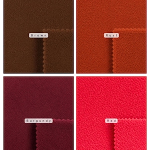 May include: A grid of four fabric swatches featuring a soft, textured fleece material. The colors are labeled as Brown, Rust, Burgundy, and Red. Each section displays a folded edge with a scalloped trim, showcasing the consistent pile texture.