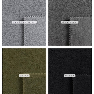 May include: A grid of four fabric swatches with a textured fleece surface. The colors are labeled as Heather Grey, Charcoal, Olive, and Black. Each swatch features a pinked edge, showcasing the soft, fuzzy material in four distinct neutral tones.