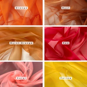 May include: A collection of sheer fabric swatches in various colors. The colors include orange, rust, burnt orange, red, coral, and yellow. Each swatch has a label with its corresponding color name.
