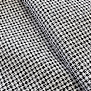May include: Close-up of a black and white gingham fabric. The fabric is folded, showing the pattern at different angles. The pattern consists of evenly spaced, small squares in a classic checkerboard design.