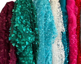 May include: Assortment of sheer fabric with butterfly cutouts in various colors, including teal, blue, white, pink, and red.