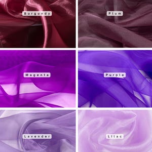 May include: A collection of six swatches of sheer fabric in various shades of purple and violet. The colors include burgundy, plum, magenta, purple, lavender, and lilac. Each swatch has a white label with the color name.