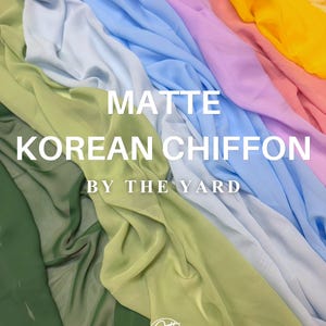 May include: A display of matte Korean chiffon fabric in various colors, including green, yellow, pink, and blue. The fabric is arranged in flowing folds, with the words "MATTE KOREAN CHIFFON BY THE YARD" in white text.