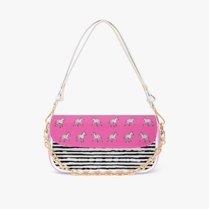 May include: A rectangular shoulder bag featuring a pink flap with a repeating black and white zebra pattern. The lower section has horizontal black and white stripes. It includes a white shoulder strap and a decorative gold-tone chain link.