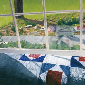 May include: A view from a window shows a green lawn with a tree and a walkway.  A blue and white quilt with red accents is in the foreground.