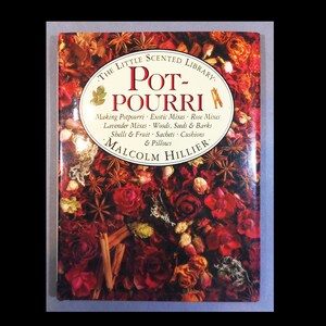 May include: A book titled "Pot-Pourri" from "The Little Scented Library" with a cover featuring a floral arrangement of red roses, cinnamon sticks, and star anise. The author's name, Malcolm Hillier, is also visible.