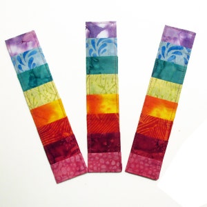 Quilted bookmarks made with eight rainbow colored fabrics