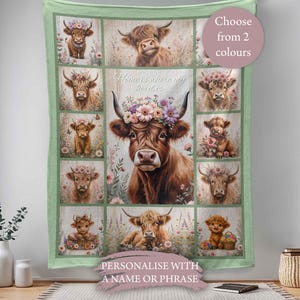 May include: A light green blanket with a grid pattern showcasing watercolour illustrations of Highland cows. The central image features a cow with a floral crown. Text reads "Home is where my herd is". Choose from 2 colours.
