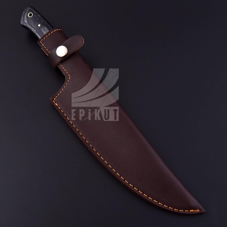 May include: A brown leather knife sheath with a stitched edge and a silver button. The sheath is designed to fit a long, straight-bladed knife.