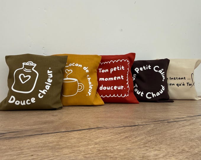 Featured listing image: Natural dry hot water bottle with mixed cherry pits and rice grains, for hot or cold use, and its cover.