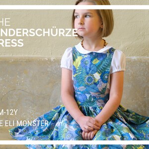 May include: A girl wearing a blue and green floral dress with a white collar and short sleeves. The dress has a full skirt and is sitting on a bench. The text "THE KINDERSCHÜRZE DRESS" and "12M-12Y THE ELI MONSTER" is visible in the image.