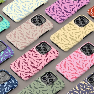 May include: A collection of phone cases with a repeating pattern of bats in various colors, including pink, yellow, green, blue, and purple.