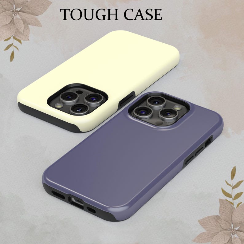 May include: Two phone cases, one cream colored and one purple, with a raised camera lens area. The text "TOUGH CASE" is at the top of the image.
