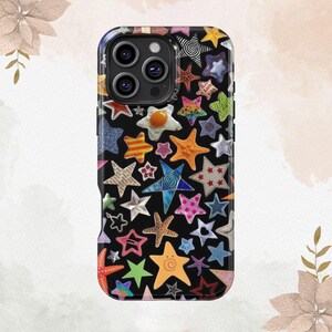 May include: A black phone case with a colorful star pattern. The stars are in various colors, including red, blue, green, yellow, and orange. Some of the stars have a 3D effect, while others are flat. The case has a cutout for the camera lens.