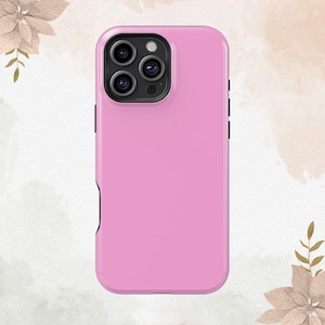 May include: A pink phone case with a black camera lens cutout.