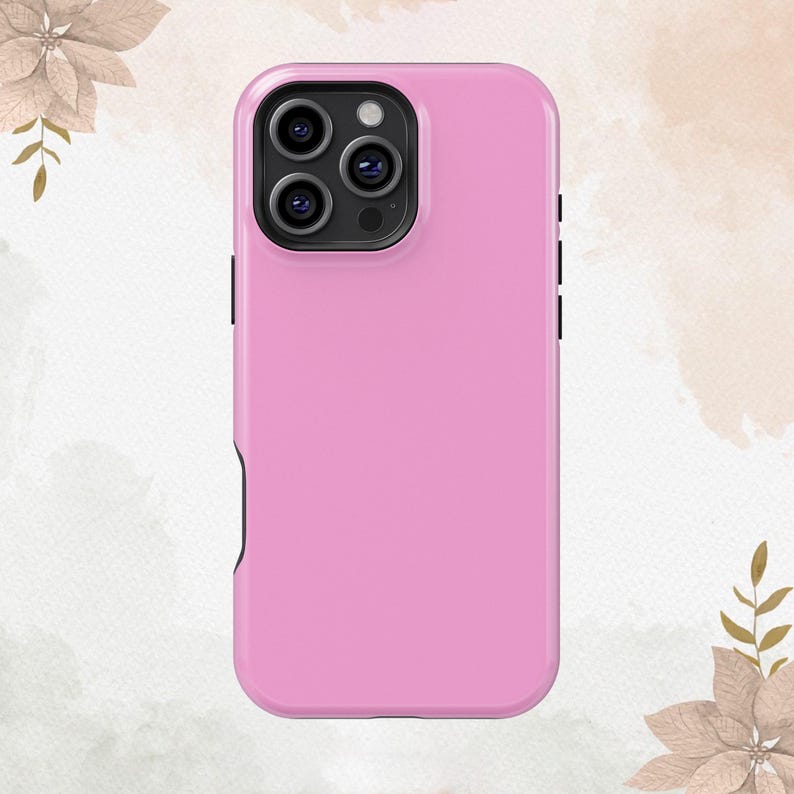 May include: A pink phone case with a black camera lens cutout.