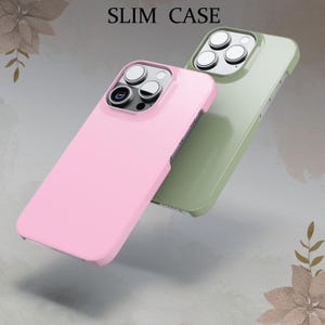 May include: Two phone cases, one pink and one green, with raised camera lens covers. The cases are designed to fit a smartphone with a triple camera system. The text "SLIM CASE" is printed on the top of the image.