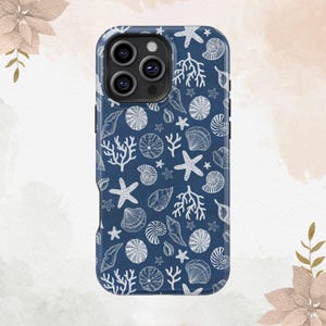 May include: A navy blue phone case featuring a repeating pattern of white seashells, starfish, and coral. The case has a glossy finish and a camera module with three lenses.