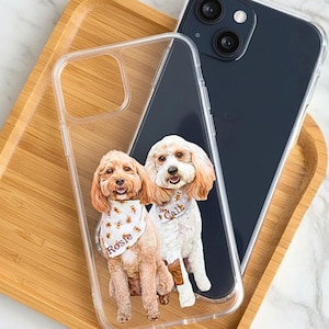 May include: Clear phone case with custom illustrations of two dogs, one wearing a bandana that says "Rosie" and the other wearing a collar that says "Callie". A black phone is next to the clear case. The text "NO EXTRA CHARGE FOR MULTIPLE PETS" is at the bottom.