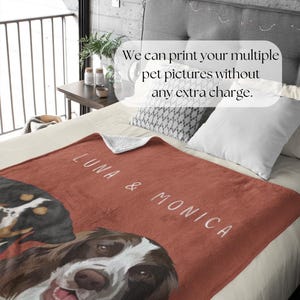 May include: A red fleece blanket with two dog portraits, one of a brown and white dog and one of a black and brown dog. The blanket has the text "LUNA & MONICA" printed on it.